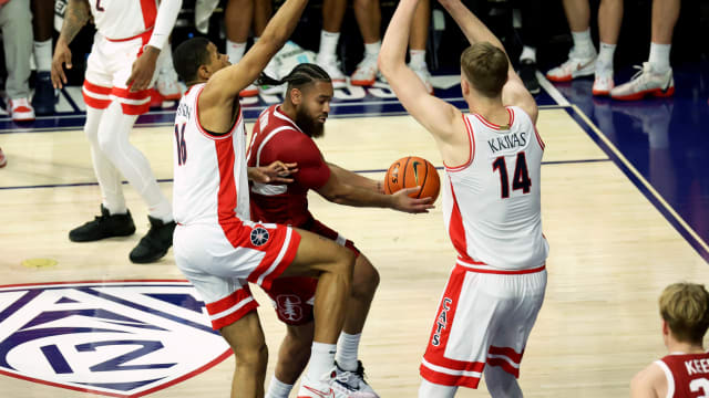 Feb 4, 2024; Tucson, Arizona, USA; Stanford Cardinal guard Jared Bynum (1) drives to the basket against Arizona Wildcats forward Keshad Johnson (16) and center Motiejus Krivas (14) during the first half at McKale Center. Mandatory Credit: Zachary BonDurant-USA TODAY Sports